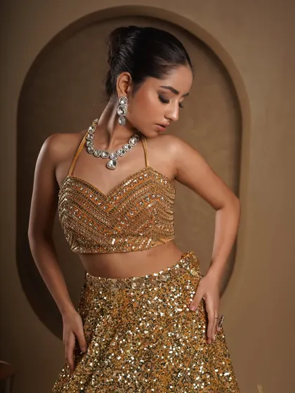 A closer portrait to showcase the intricate beadwork on the halter top and the matching diamond necklace. This type of shot is essential for showing the quality and detail of high-end fashion and jewelry.