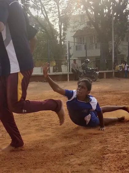 Another angle of a dive, showing the technique of getting low to the ground to make a successful tag while maintaining speed.
