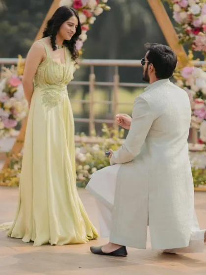 The moment of the proposal during the roka ceremony. This classic shot captures the groom on one knee, a timeless symbol of love and commitment.