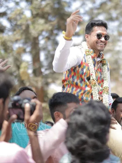 The groom making a grand entry on the shoulders of his friends and family, a true celebration of the new journey ahead.