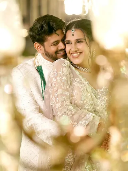Another romantic, through-the-lights shot. The focus is on their happy connection, and her makeup just enhances her natural glow.