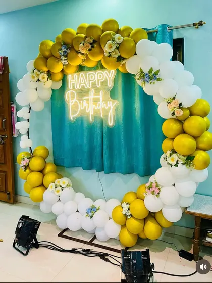 Another view of the yellow and white circular balloon setup, showing the placement of PAR lights to illuminate the decoration.