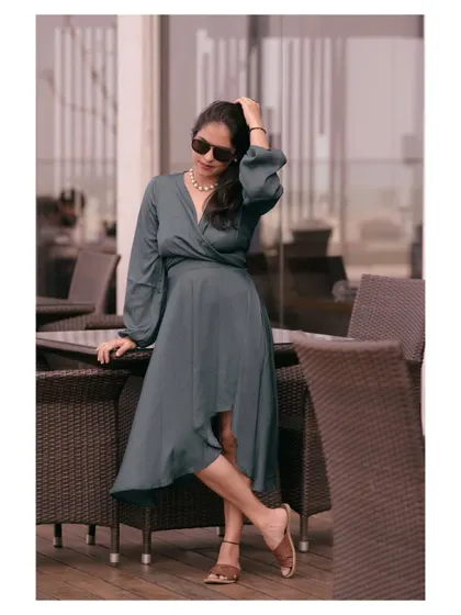A relaxed outdoor portrait in a casual dress. This shot is perfect for a lifestyle brand, capturing a moment of effortless style in a natural setting.