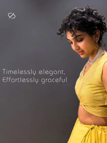 Timelessly elegant, effortlessly graceful. This close-up highlights the textured fabric and modern cut of the yellow lehenga's blouse.