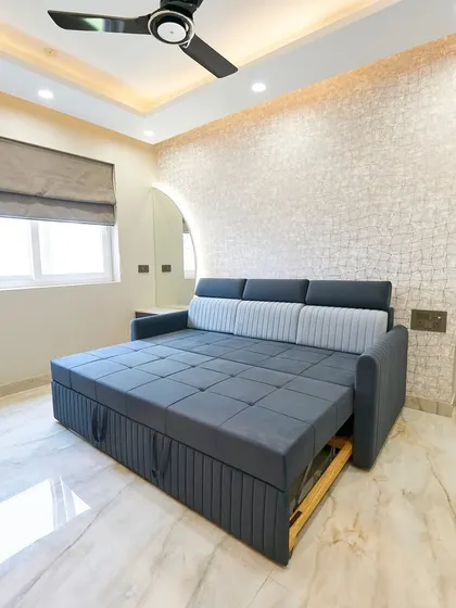 Another view of the sofa bed, highlighting its easy-to-use pull-out mechanism and built-in storage. This is a great example of smart furniture for modern homes.