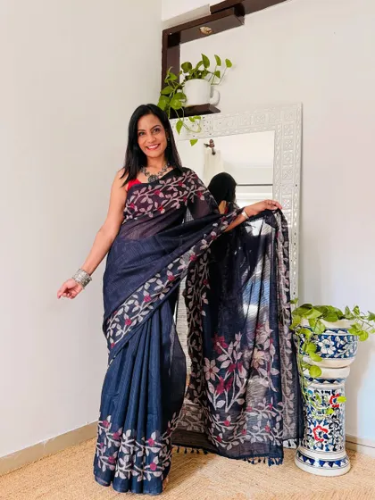This navy blue saree with a floral printed border and pallu is very elegant. It's a great option for a more formal work event or a client meeting.