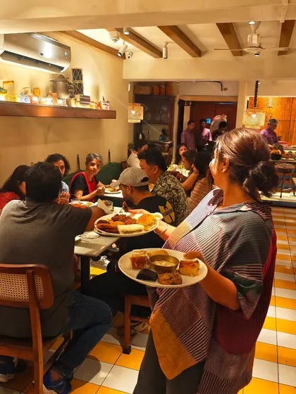 Another shot from our home chef collaboration, with plates full of diverse Indian snacks being served to eager guests. The energy in the room was just incredible.