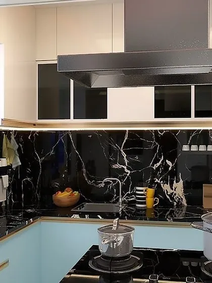 A kitchen with a view. This design from our 'Confident Oxygen' project in Bangalore features a bold black marble backsplash and countertop, creating a dramatic and luxurious feel.