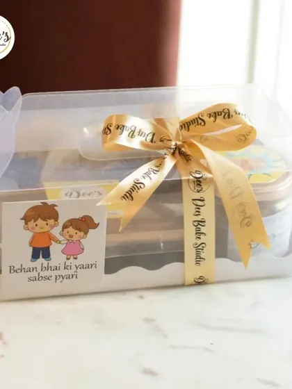 A cute and personal Rakhi gift box. The "Behen bhai ki yaari sabse pyari" sticker adds a lovely touch to this hamper filled with delicious baked treats.