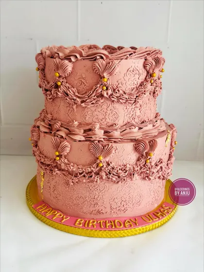 A classic beauty for an 80th birthday. This two-tier vintage-style cake features detailed piping work, creating a timeless and elegant centerpiece.