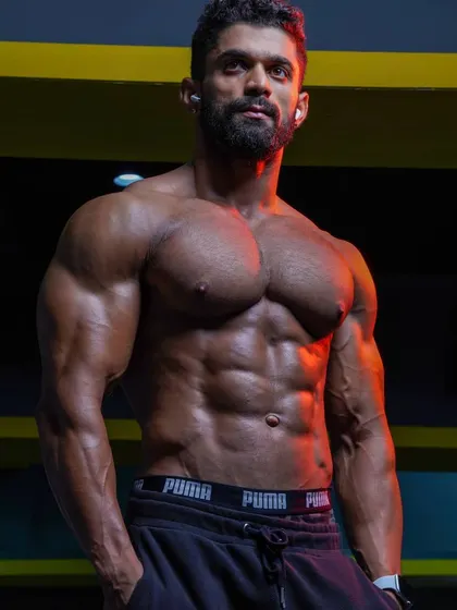A moment of focus, showcasing the results of a strict diet and training regimen. The lighting highlights the separation in the abdominal and pectoral muscles.