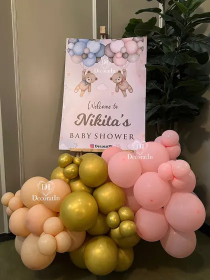 A personalized welcome sign for Nikita's baby shower, decorated with pink and gold balloons.