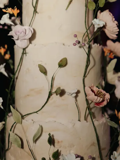 A close-up of Julia and Aditya's exquisite wedding cake, adorned with delicate, lifelike sugar flowers. A true work of art.