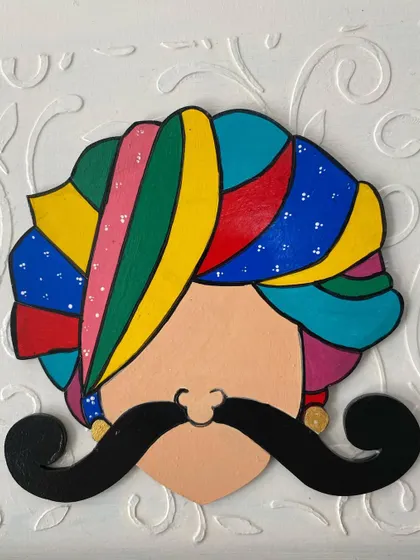A close-up of the hand-painted Rajasthani turban man, a popular motif for adding a touch of Indian tradition to my wall decor pieces.