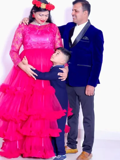 A heartwarming family maternity photo, with the older brother hugging his mother's baby bump.