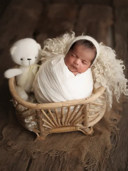 This family traveled all the way from Dahanu for their session, and I'm so grateful. We created this beautiful memory with their 15-day-old baby boy, cozy in a basket with his teddy.