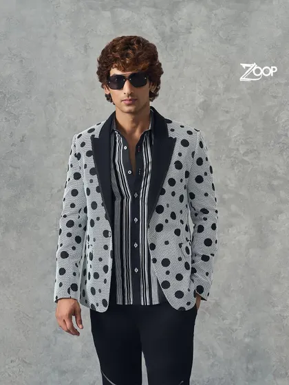 A closer look at our polka dot blazer. The contrasting black lapel and bold pattern make this a standout piece for the fashion-forward man.
