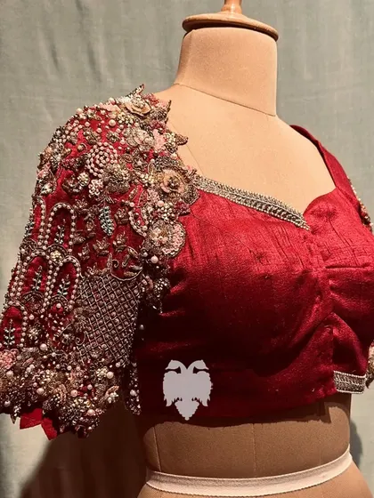 A close-up of the statement sleeve on Kala's blouse, hand-embellished with pearls, sequins, and zardosi.