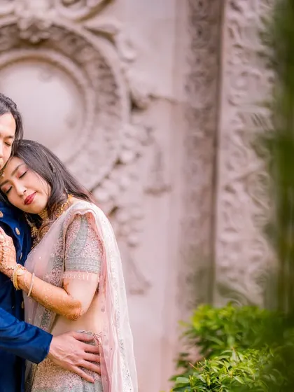 A quiet, peaceful moment of a couple in traditional Indian attire. The natural framing of the greenery adds an intimate feel to this beautiful portrait.