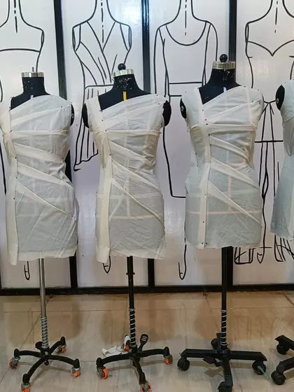 Mannequins displaying foundational draping exercises. These basic forms are the building blocks for creating more complex and creative garment structures.