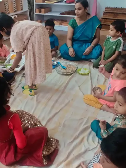 Children enjoying "Ellu Bella," a traditional Sankranti mixture. Sharing festive foods is a sensory way for children to connect with cultural celebrations.