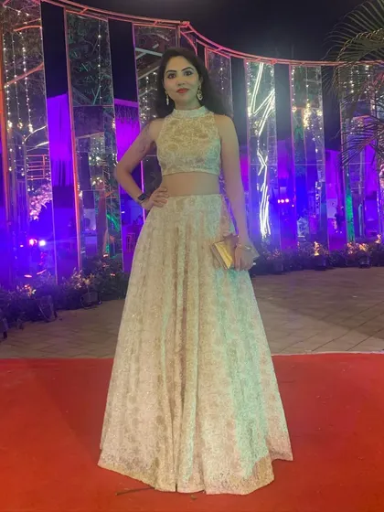 A full-length view of the elegant white chikankari lehenga. The intricate threadwork on the fabric gives it a luxurious texture, and the modern cut makes it perfect for a glamorous evening affair.