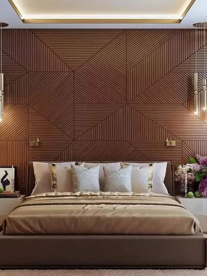 This bedroom features a stunning accent wall made of geometric wood paneling. The custom design adds texture and depth to the space, complemented by modern pendant lights.