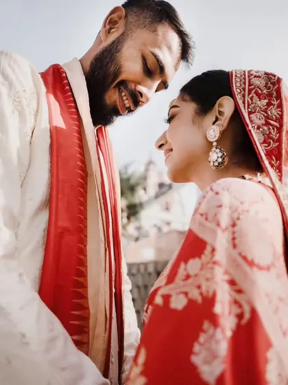 A close-up of the same intimate moment, focusing on their happy, smiling expressions and the genuine connection between them.