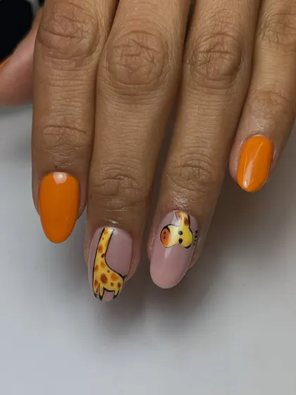 A close-up of the adorable hand-painted giraffe. You can see the detail in the giraffe's face and the pattern of its neck, set against a soft pink and vibrant orange.
