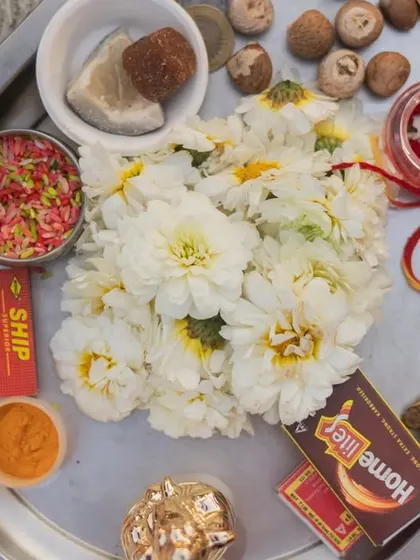 A traditional puja thali prepared for the wedding ceremony, with flowers, kumkum, and other essential items, all beautifully arranged.