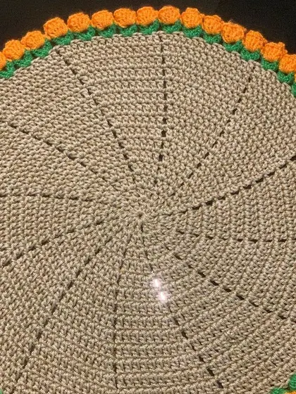 This is from my tulip collection, featuring a simple beige doily with a vibrant orange tulip border. The 3D effect of the tulips makes it a unique piece.