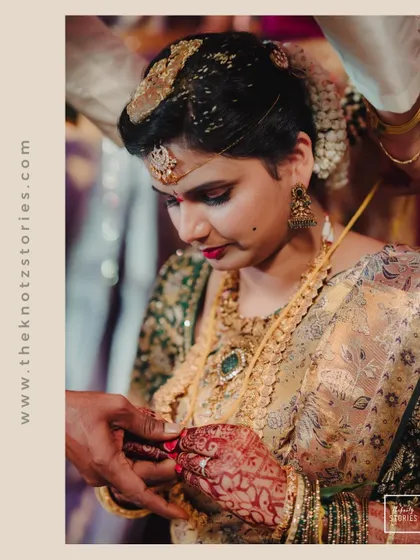 The bride receiving a toe ring, another significant ritual in many South Indian weddings, captured in beautiful detail.