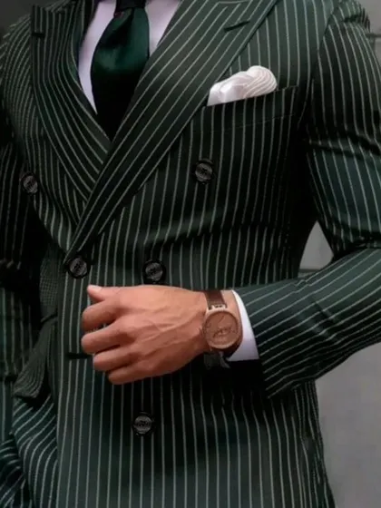 A classic dark green pinstripe double-breasted suit. This is a powerful, vintage-inspired look that is very much in style.