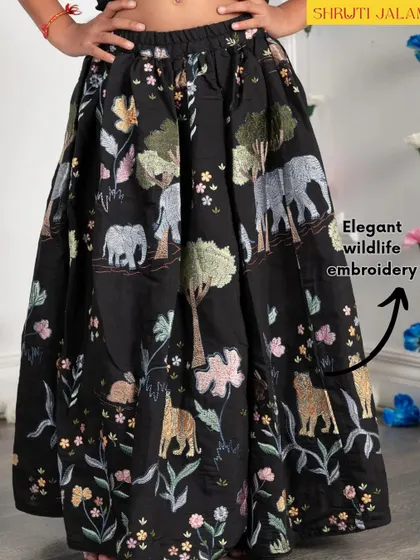 A close-up of the elegant wildlife embroidery on the skirt of my black lehenga set. I use these details to tell a story and add a unique touch to my designs.