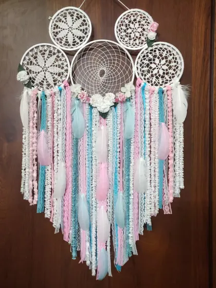 Everything is better with a unicorn. This pastel cluster dreamcatcher in pink, blue, and white was inspired by unicorn colors, making it a magical addition for a child's room.