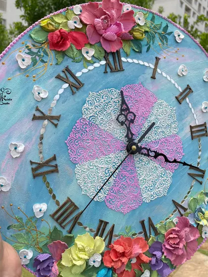 A detailed shot of the custom blue and pink clock. The central pattern is created with two different colors of texture paste, creating a pinwheel effect that is both playful and elegant.