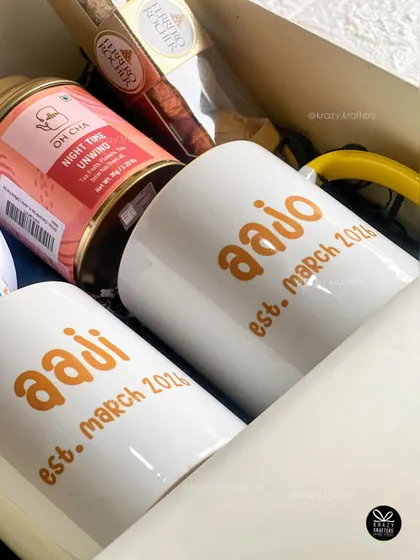 A detailed shot of our personalized 'Aaji' and 'Aajo' mugs, showing the custom text with the established date of becoming grandparents.