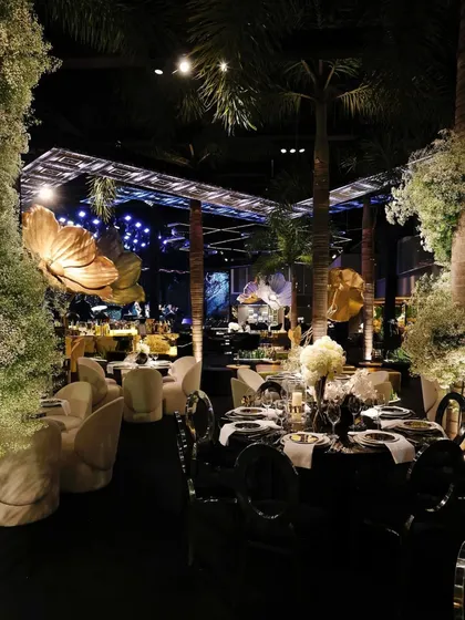 For a glamorous engagement party, I transformed the space into a lustrous affair. The design featured a dramatic black, gold, and silver palette, with oversized metallic floral sculptures and sophisticated lighting to create a high-energy, modern, and unforgettable night.