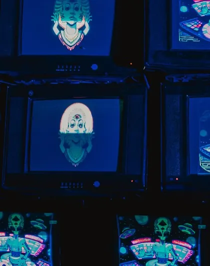 An installation of stacked vintage television sets displaying psychedelic, custom-made visuals. This retro-tech art piece was a major focal point and conversation starter.