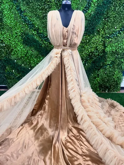 Another view of our stunning beige ruffle gown, showcasing its elegant design and beautiful fabric. This gown is perfect for a high-fashion photoshoot.