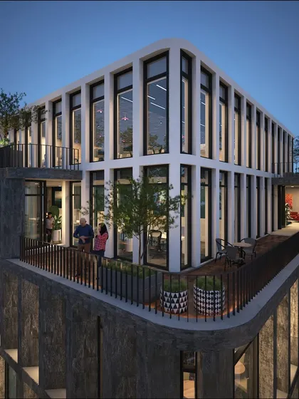 A rendering of an office building in Koramangala, featuring rounded corners and deep-set windows. The design includes terrace gardens on multiple levels to integrate nature into the workspace.