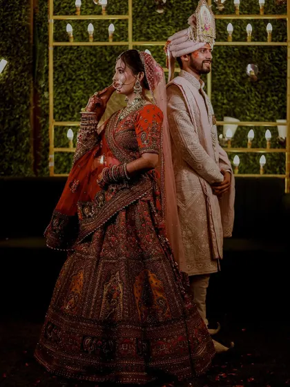 A stylish portrait of the bride and groom standing back-to-back. This pose creates a modern and confident image, highlighting their beautiful wedding attire.