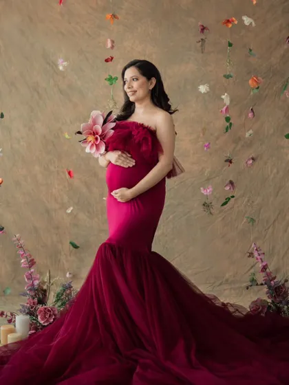 A full-length portrait showcasing a magnificent red tulle gown against our floral backdrop. I love creating these artistic and dreamy maternity photos.