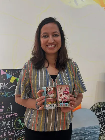 A participant with her finished miniature cafe-in-a-tin. The level of detail is incredible.