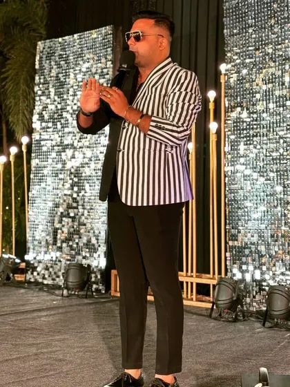 Commanding the stage in my black and white blazer. The shimmering backdrop complements the outfit perfectly for a glamorous event.