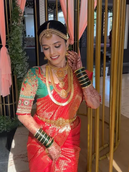 A happy, candid shot of Priya on her wedding day. The makeup is designed to look great both in person and in photographs, capturing her joy perfectly.