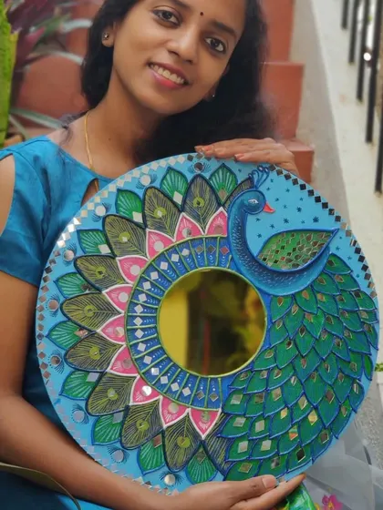 Here I am with my finished peacock Lippan mirror art. It’s a joy to create these pieces that combine traditional techniques with my own artistic style.