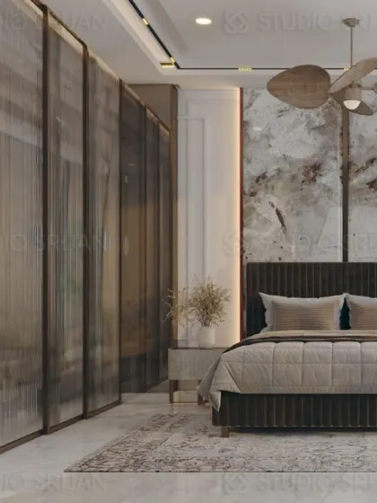 This shot highlights the use of fluted glass panels for the wardrobe, which adds texture and partially conceals the contents for a clean look.