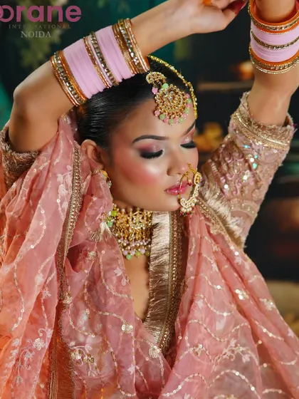 An expressive pose that highlights the soft, flowing fabric of the outfit and the delicate makeup.