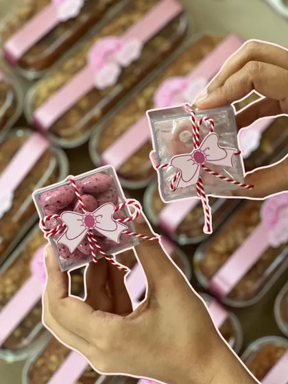 Tiny boxes of rose-flavored dragees, tied with baker's twine and a bow tag, were one of the sweet treats included in the announcement hampers.